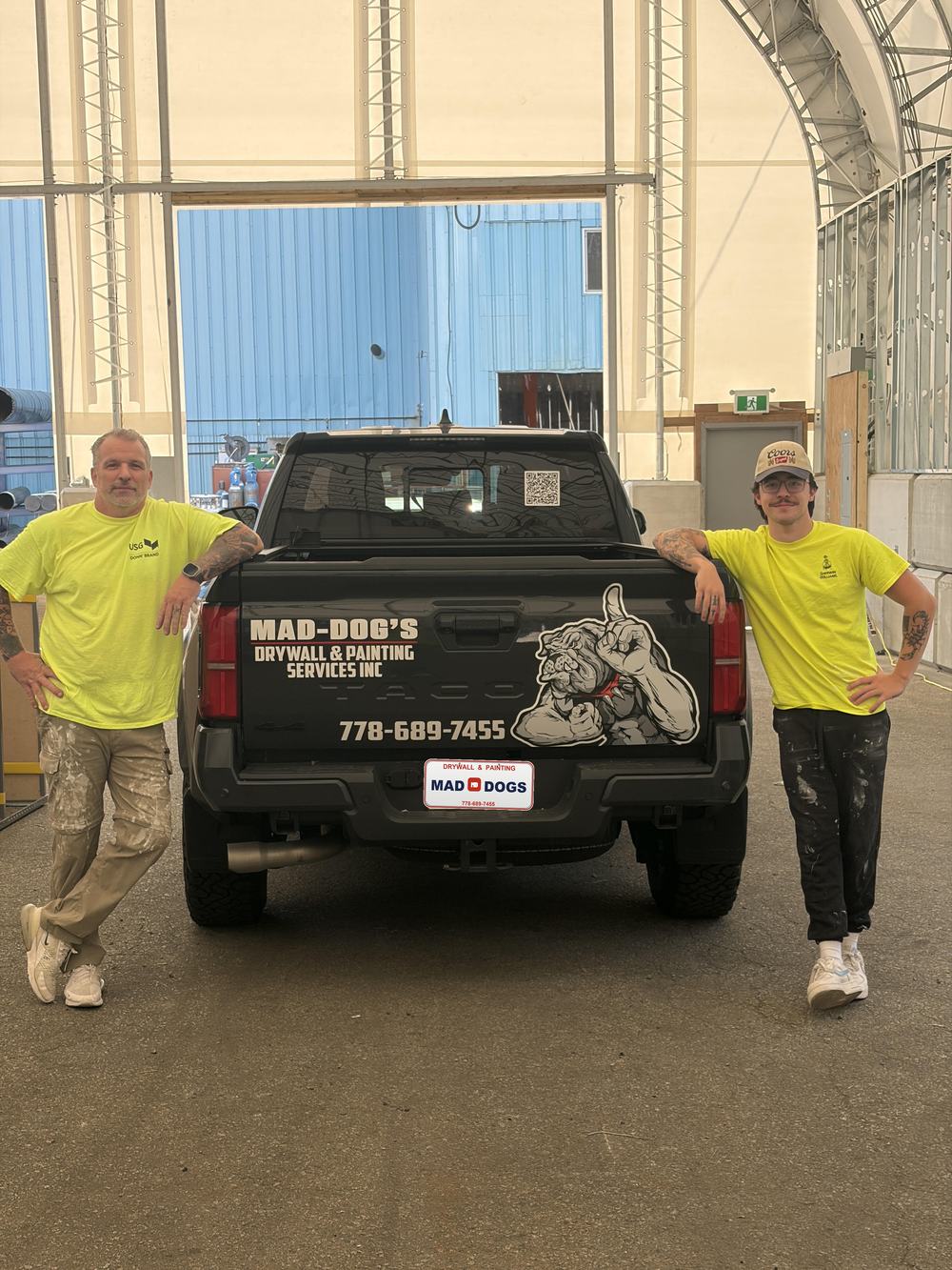 Mike Madden and Dylan Madden of Mad-Dog's Drywall & Painting in front of the company truck